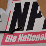 Ebenso auf dem Foto von Jacky Süßdorf zu sehen: das Parteilogo der NPD. Symbolfoto: dpa-Bildfunk/Hendrik Schmidt